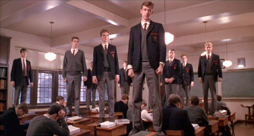 Dead Poets Society: Boys stand on their desktops like speechless zombies